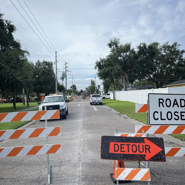 Sun State Traffic Control road closure setup with detour signage in Florida residential area