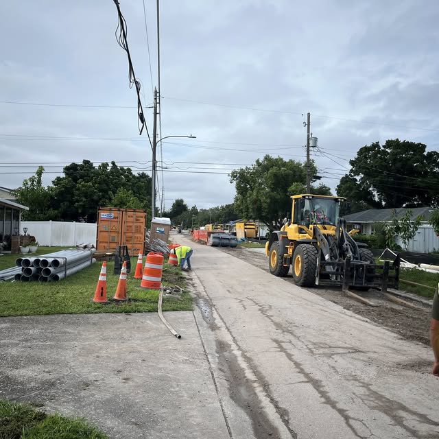 Sun State Traffic Control utility project setup with construction equipment and traffic cones in Florida