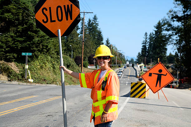 Certified traffic flagger performing manual traffic control on a Jacksonville FL construction zone